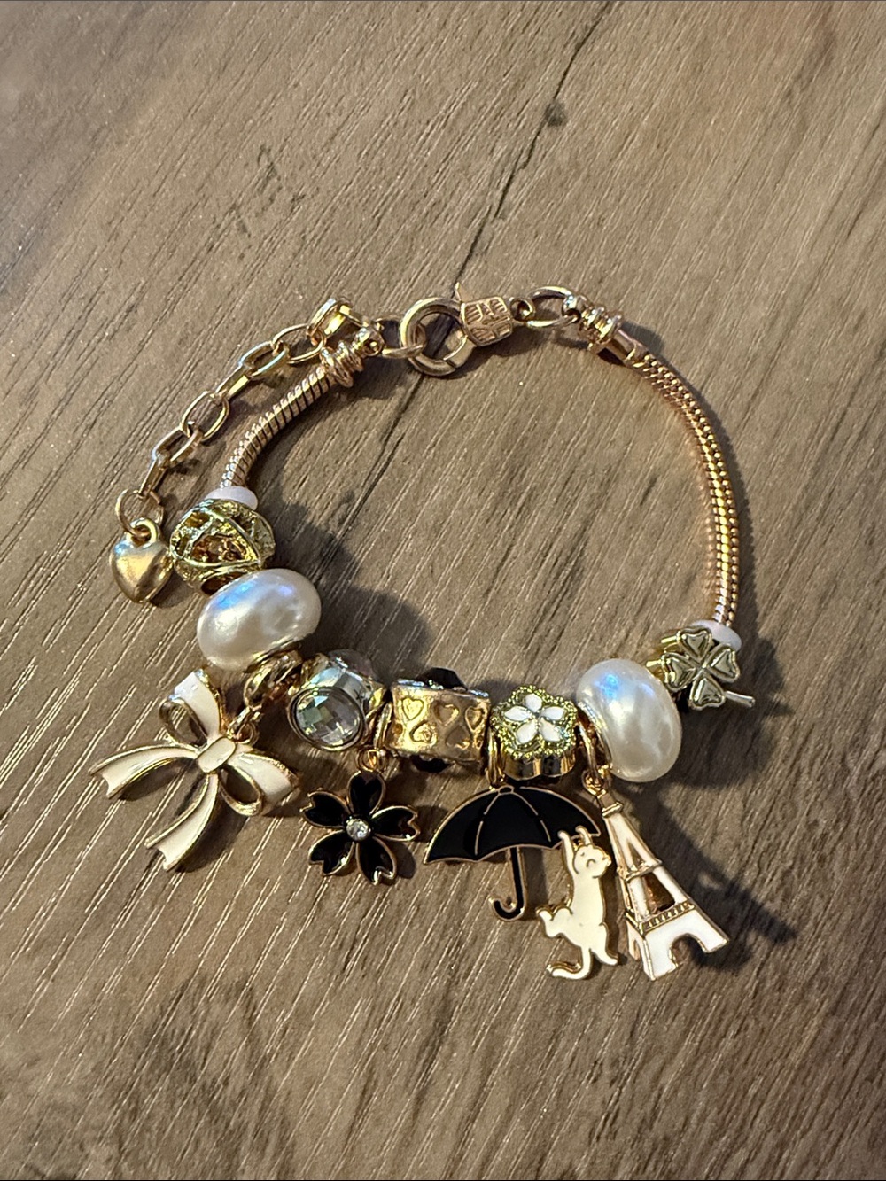 Gold Charm Bracelet with Pearl and Black Enamel Accents